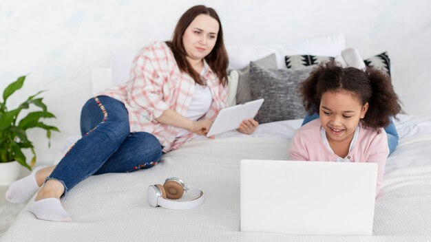 Mother and daughter working from home together