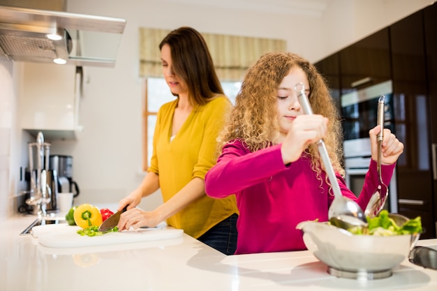 Madre e figlia che lavora nella cucina