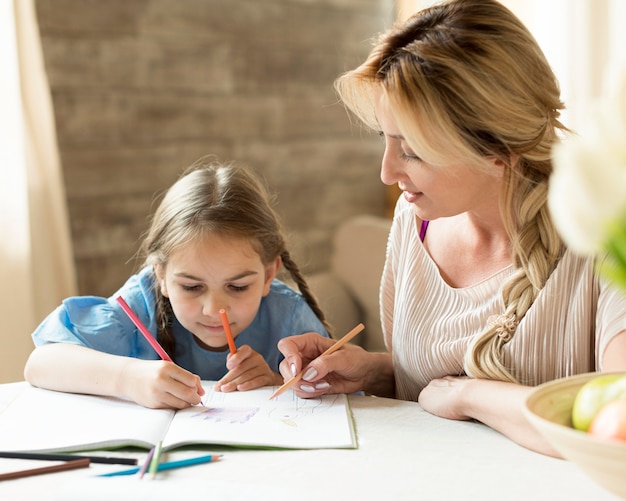 Mother doing homework together with her daughter