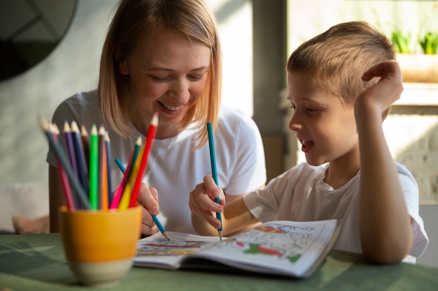 Free photo mother educating her autistic son at home