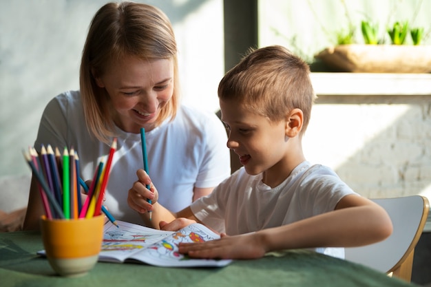 Free photo mother educating her autistic son at home