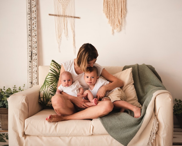 Free photo mother embracing children front view