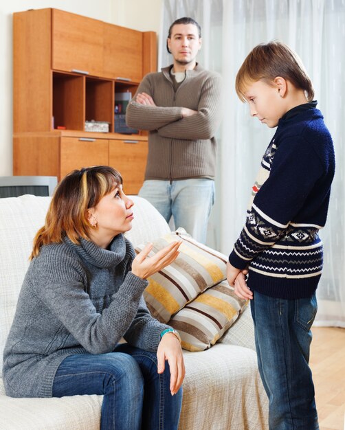 Mother and father scolding teenager