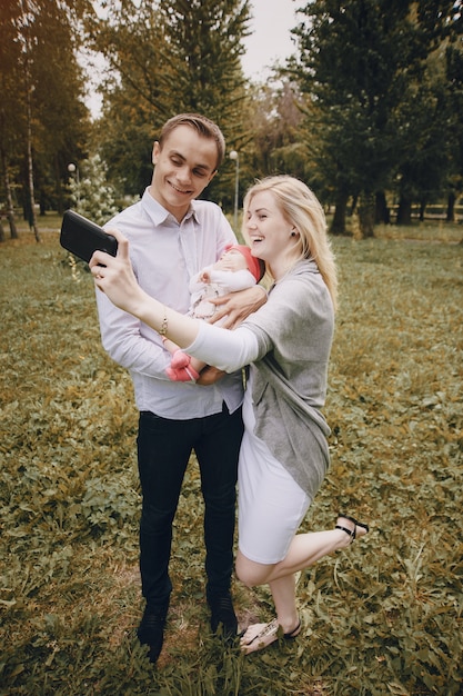 Mother and father taking a picture with their baby