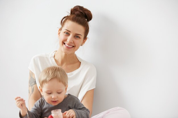 Mother feeding her baby boy with spoon