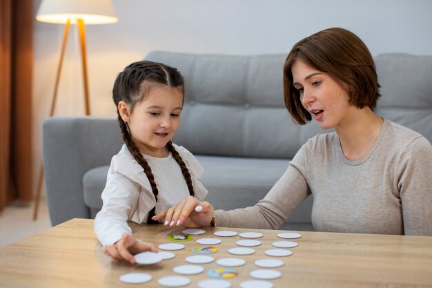 Mother and girl playing game front view