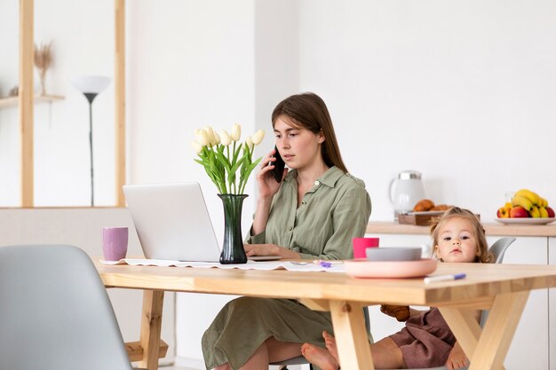 Mother and girl sitting at table