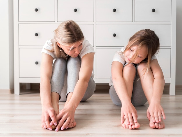 Free photo mother and girl stretch