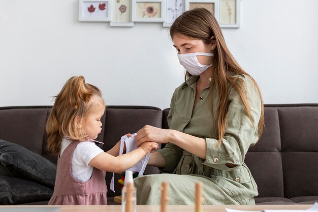 Mother and girl with medical masks