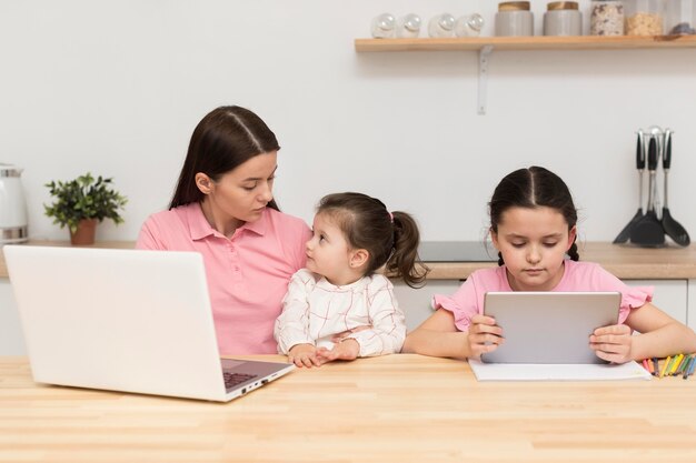 Mother and girls at table