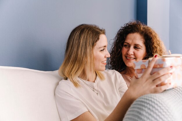 Mother giving gift to daughter