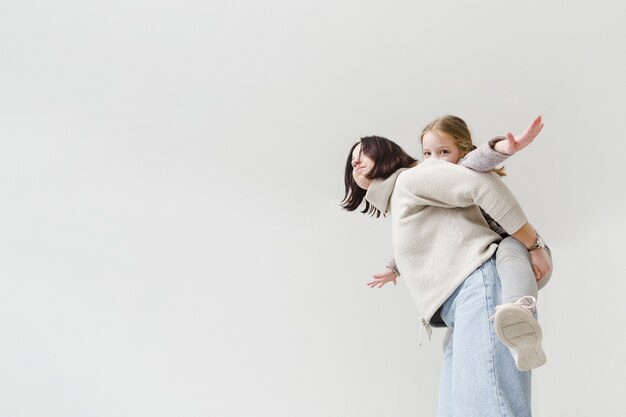 mother giving a piggyback ride