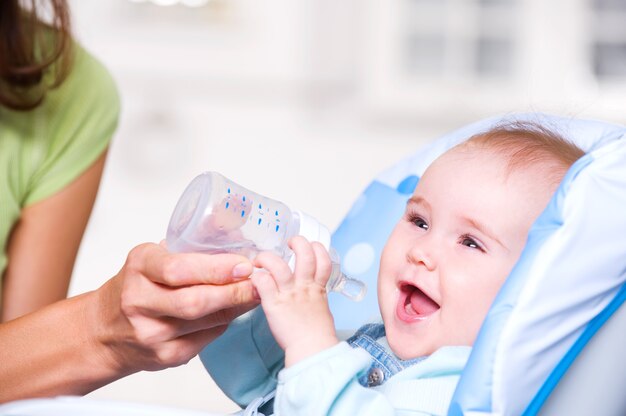 Mother giving the water to  baby