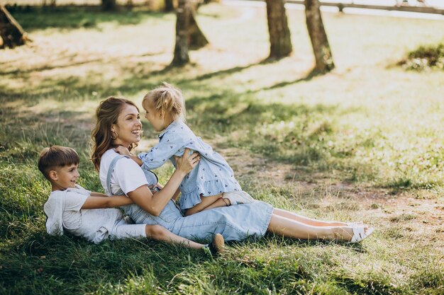 Mother having fun with son and daughter in park