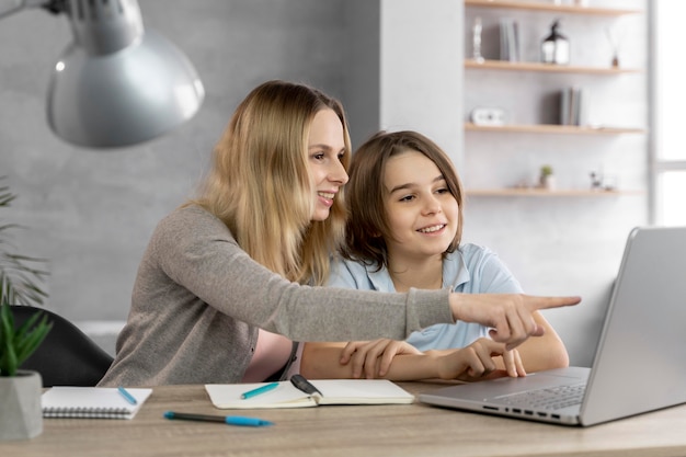 Mother helping daughter to study