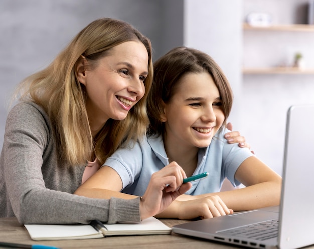 Free photo mother helping daughter to study