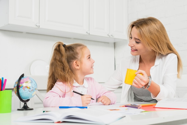 Mother helping daughter with her homework