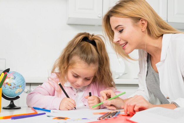 Mother helping daughter with her homework