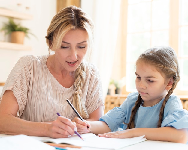 Mother helping daughter with homework