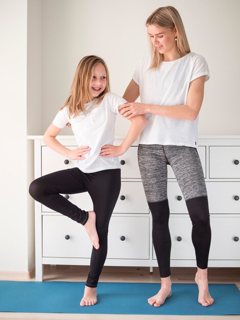 mother helping girl to train