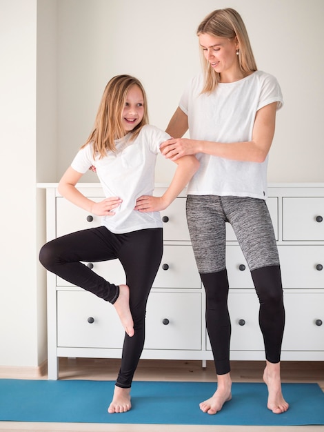 Mother helping girl to train