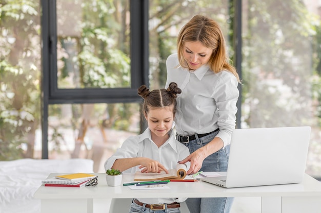 Mother helping her daughter study