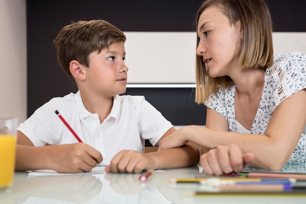 Mother helping son with homework