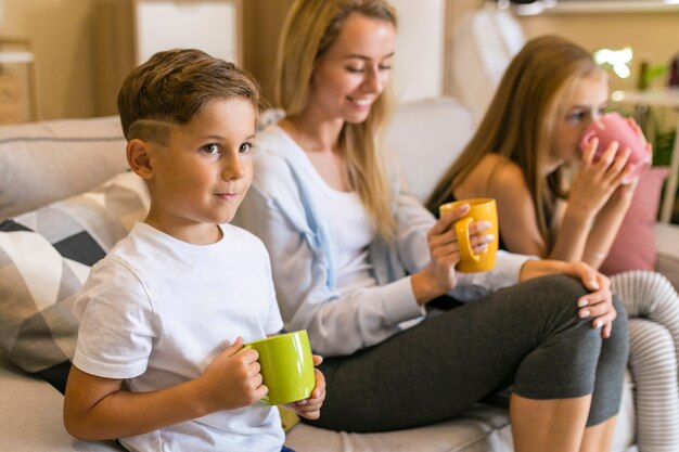 Mother and her children drinking from cups