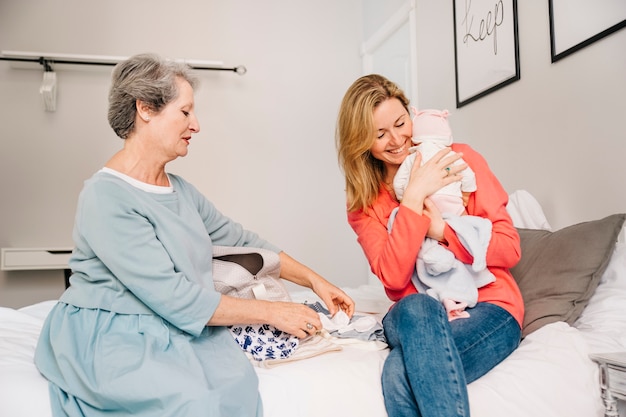 Mother holding baby in bedroom