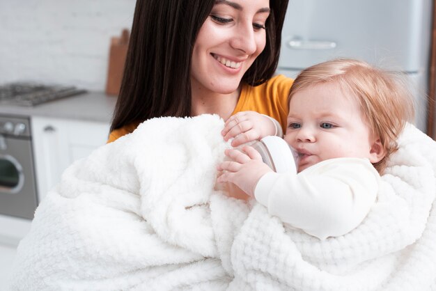 Mother holding baby in fluffy blanket