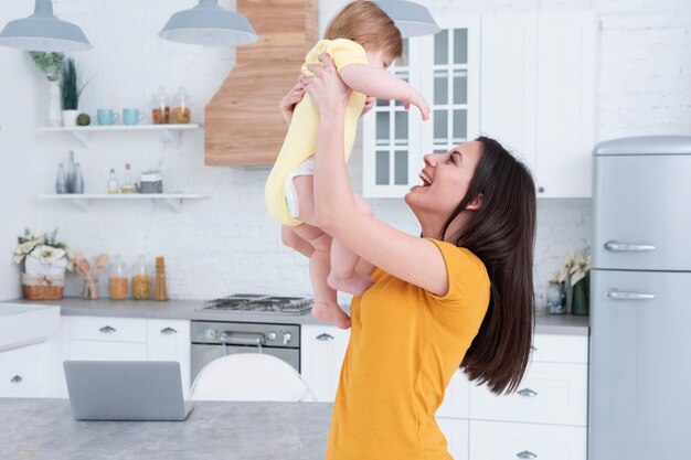 Mother holding baby in the kitchen