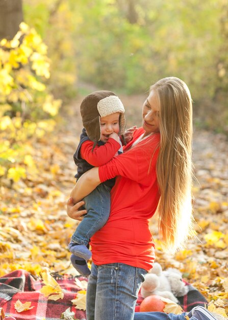 Mother holding baby with fur cap