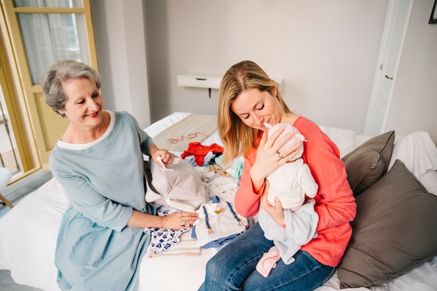 Free photo mother holding baby