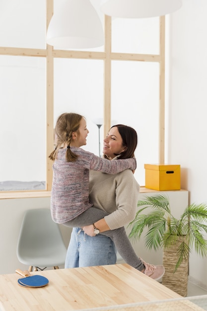 Free photo mother holding cute daughter