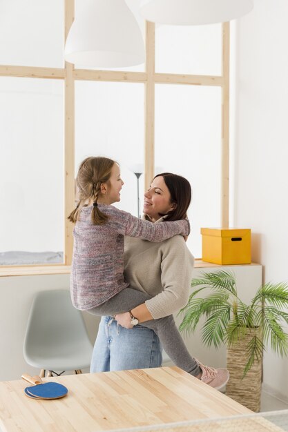 mother holding cute daughter