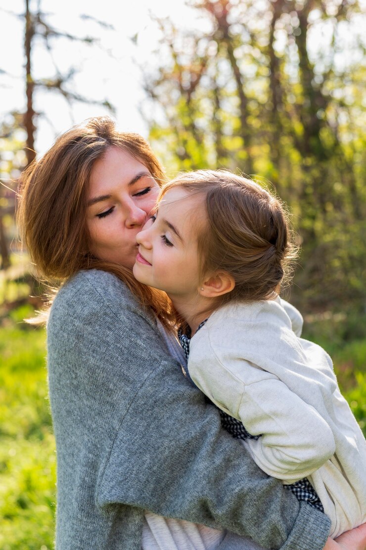 Free Photo mother holding happy child side view
