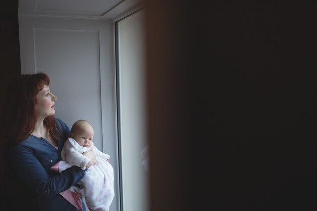 Mother holding her baby in arms at cafÃ©