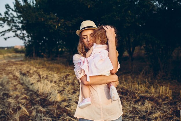 Mother holding her daughter in her arms