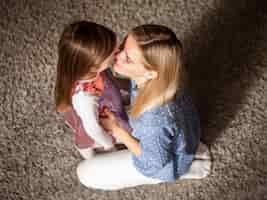 Free photo mother holding in love with her daughter