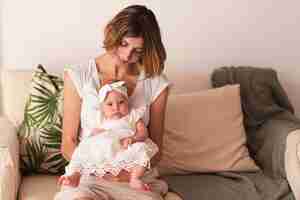 Free photo mother holding newborn baby girl