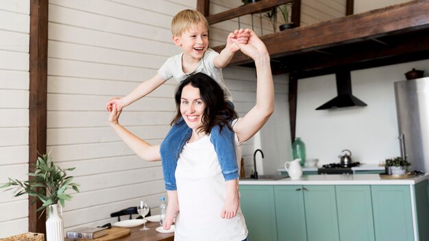 Mother Holding Son On Shoulders