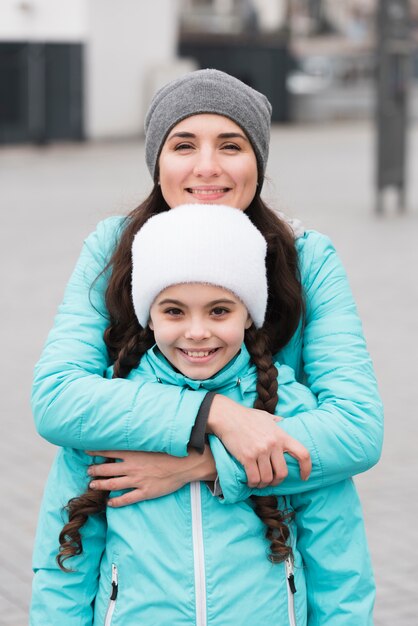 Mother hugging daughter