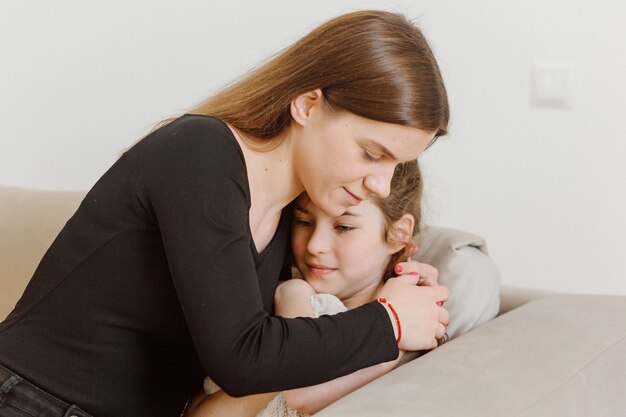 Mother hugging scared daughter