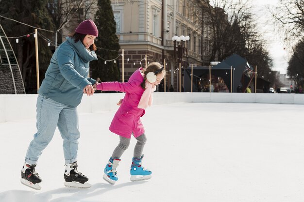 Mother and kid ice skating