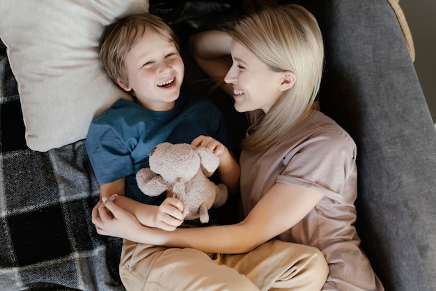 Mother and kid with toy on couch