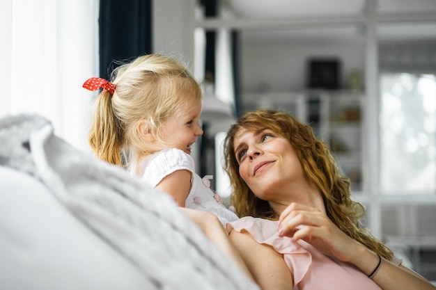 Free photo mother kisses her daughter