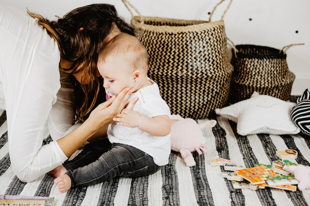 Free photo mother kissing baby