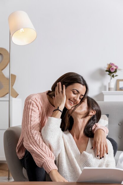 Mother kissing girl on cheek