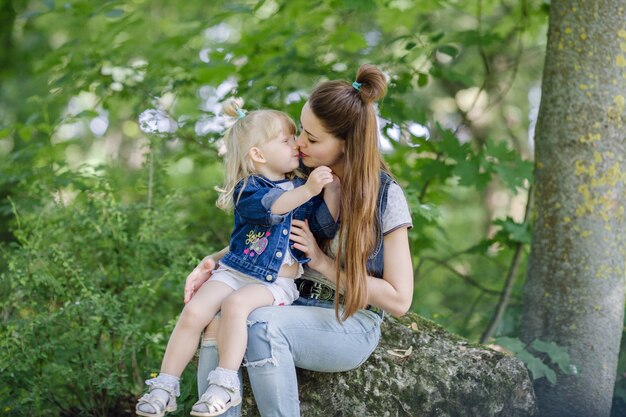 Mother kissing her blond son in her mouth