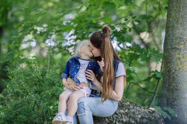 Mother kissing her blond son in her mouth